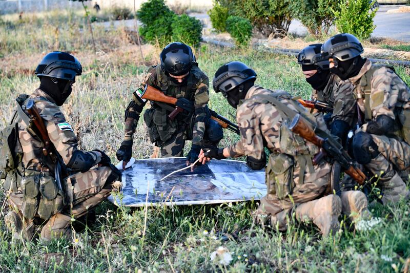 Fighters study a map during the operation in north-west Syria. 