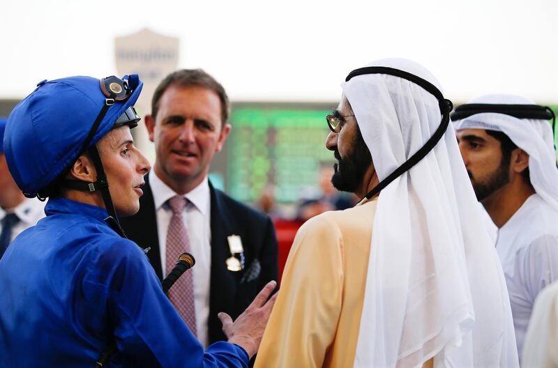 Jockey William Buick (left) of Britain, talks to Sheikh Mohammed bin Rashid.  EPA
