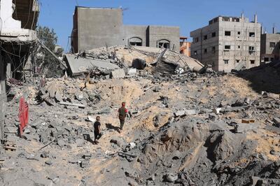 Palestinian children walk amid the rubble of a destroyed building following Israeli bombardment in Khan Younis. AFP