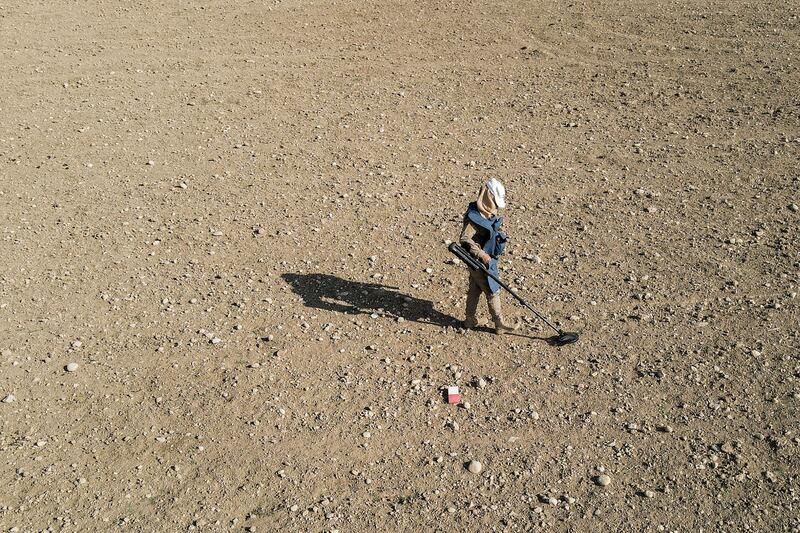 A sweeper uses a metal detector to search for landmines and unexploded ordnance near Hassan Jalad, Iraq. AFP