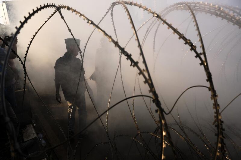 An Indonesian student walks through smoke from a burning tire during a demonstration protesting a proposed new law in Jakarta, Indonesia.  Getty