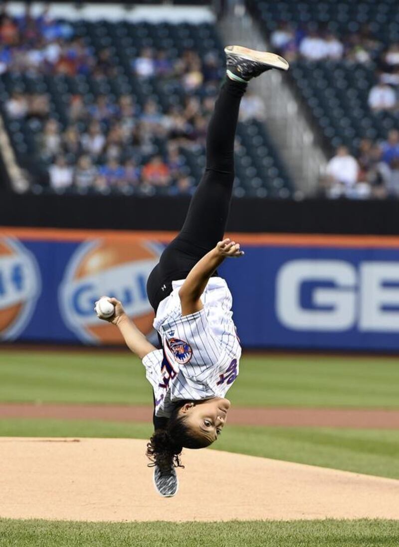 Olympic gold medallist Laurie Hernandez performs flips from the mound before throwing out the ceremonial first pitch before the baseball game between the New York Mets and the Washington Nationals in New York. Kathy Kmonicek / AP Photo