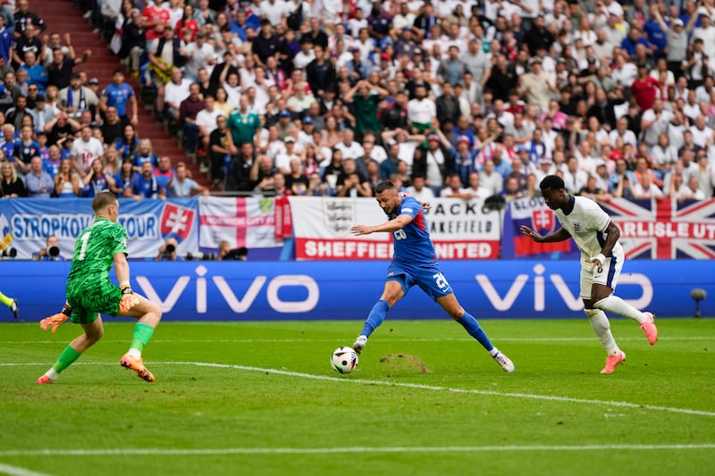 Slovakia's Ivan Schranz scores their first goal past England's goalkeeper Jordan Pickford. AP 