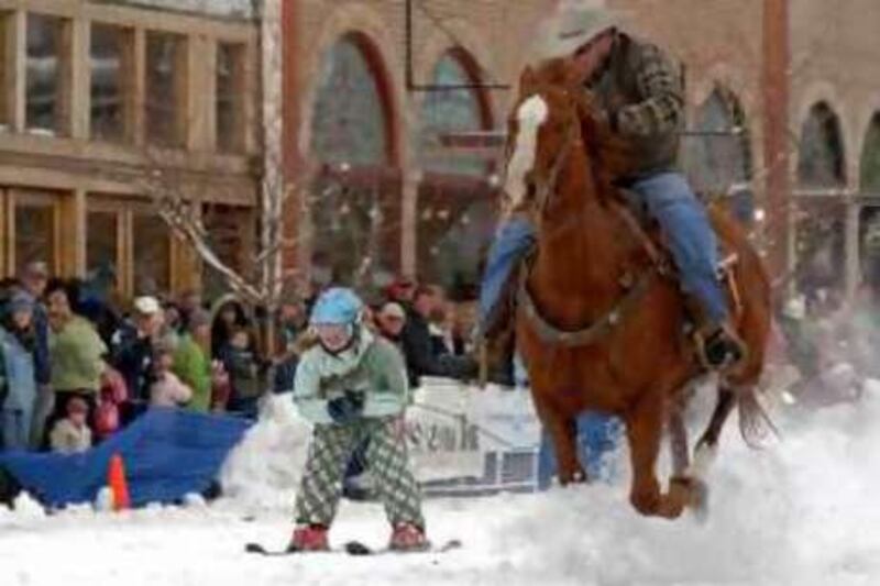 This photo, supplied by the Steamboat Ski &  Resort Corp, shows cowboys pulling skiers down Main Street on snow shovels in Steamboat Springs, Colo., on Saturday, Feb. 9, 2008 This weekend marks the 95th annual Winter Carnival for Steamboat. A western tradition that dates back to 1914. The carnival is the time of year when cowboys and ranchers and skiers and riders young and old come together.(AP Photo/ Steamboat Ski &  Resort Corp,Larry Pierce)