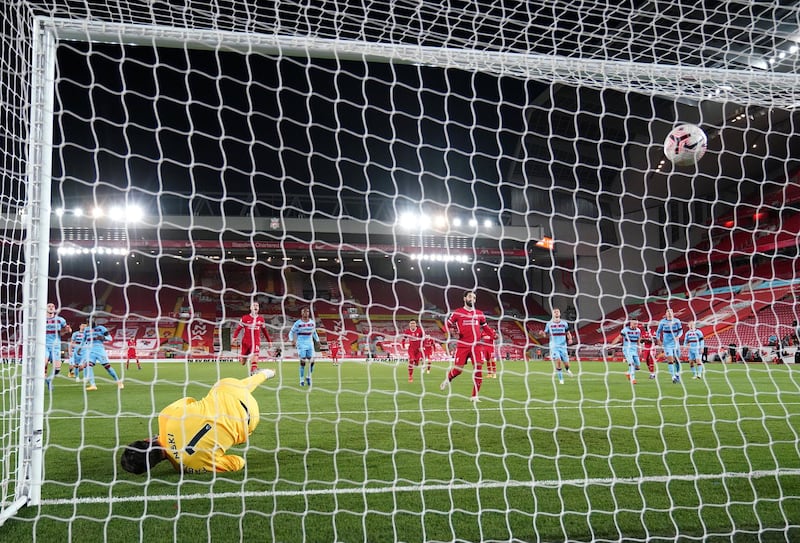 LIVERPOOL, ENGLAND - OCTOBER 31:  Lukasz Fabianski of West Ham United fails to save as Mohamed Salah of Liverpool reacts after scoring a penalty for his team's first goal during the Premier League match between Liverpool and West Ham United at Anfield on October 31, 2020 in Liverpool, England. Sporting stadiums around the UK remain under strict restrictions due to the Coronavirus Pandemic as Government social distancing laws prohibit fans inside venues resulting in games being played behind closed doors. (Photo by Jon Super - Pool/Getty Images)