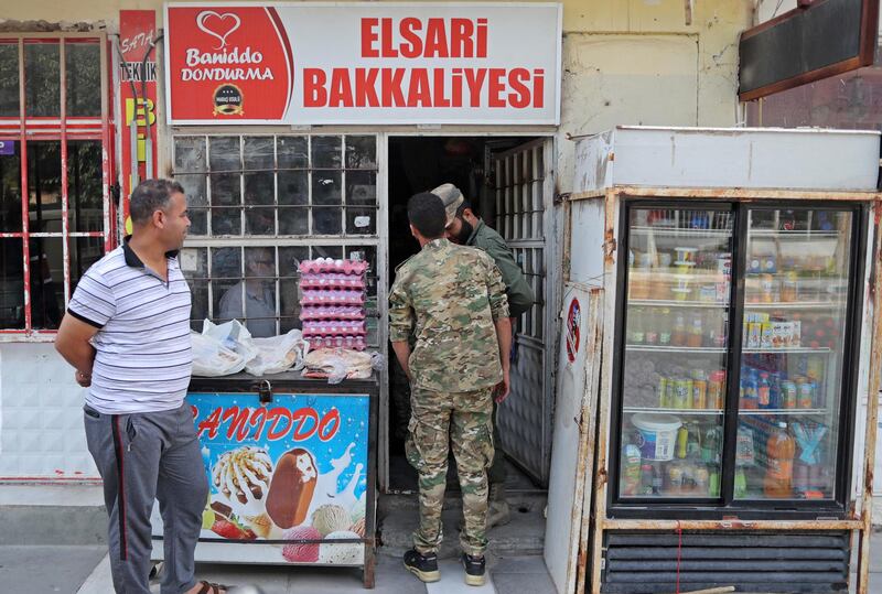 Turkish-backed Syrian fighters shopping as they return in Akcakale district in Sanliurfa, Turkey.  EPA