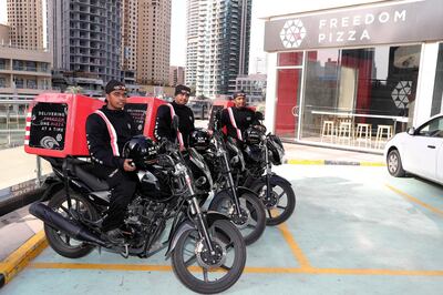 DUBAI , UNITED ARAB EMIRATES ,  November 8 , 2018 :- Left to Right ��� Ranil Suresh , Sajjad Ahmad and Didar Ul Haque delivery bikers with their bikes at the Freedom Pizza in Dubai Marina in Dubai.  ( Pawan Singh / The National )  For News. Story by Patrick Ryan