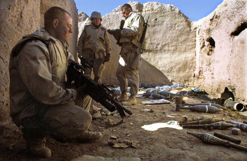 399708 04: U.S. Marine Sgt. Jerry Brown (L) of Jacksonville, North Carolina watches over a weapons cache found during a patrol near the American military compound at Kandahar Airport January 16, 2002 in Kandahar, Afghanistan. The Marines recovered mortars, rockets, rocket-propelled grenades and artillery rounds discovered in various caches near the base while on the patrol. (Photo by Mario Tama/Getty Images)