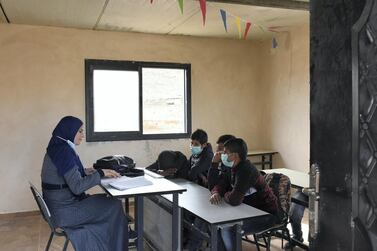 The coronavirus pandemic has prompted many schools to arrange online learning, but in Ras Al Tin, north-east of Ramallah in the occupied West Bank, the pupils must learn in person as they have no electricity or computers. Rose Scammell for The National