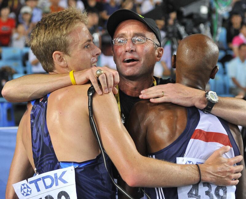 (FILES) In a file picture taken on September 4, 2011 US coach Alberto Salazar (C) hugs Britain's Mo Farah (R) and US athlete Galen Rupp (L) following the men's 5,000 metres final at the International Association of Athletics Federations (IAAF) World Championships in Daegu.  With Nike-backed athletics coach Alberto Salazar slapped with a four-year ban for doping on October 3, 2019, the US sportswear giant risks being caught up in the scandal -- its CEO is even quoted in the suspension ruling. / AFP / Jung Yeon-je
