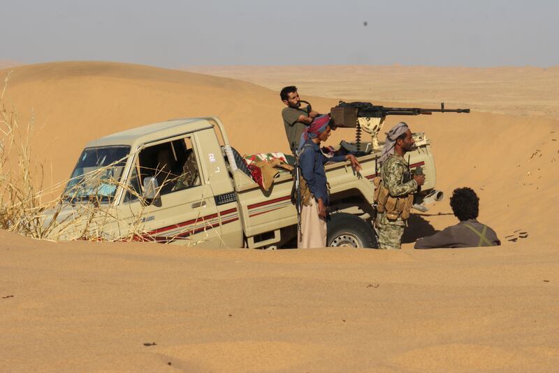 Pro-government tribal fighters take position in a desert area south-east of Marib, Yemen, on December 6, 2021. Reuters