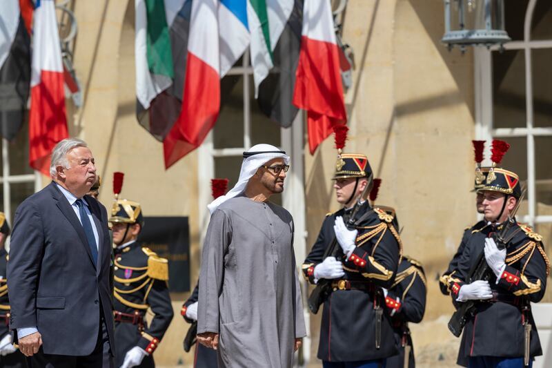 Sheikh Mohamed and Gerard Larcher, President of the French Senate, left, inspect the honour guard before a meeting at the Luxembourg Palace. Photo: Presidential Court