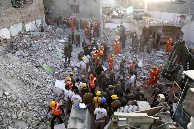 Indian Army, NDRF and SDRF personnel carry out rescue work after a building collapsed due to a gas cylinder blast during wedding party in Beawar, in the Indian state of Rajasthan on February 18, 2018.
An Indian official said on February 18 at least 18 people were killed after a blast tore through a wedding party in the western state of Rajasthan. A cooking gas cylinder exploded late on February 16, sparking a fire at the three-storey hotel in Beawar city of Ajmer district, some 200 kilometres from state capital Jaipur. 
 / AFP PHOTO / -