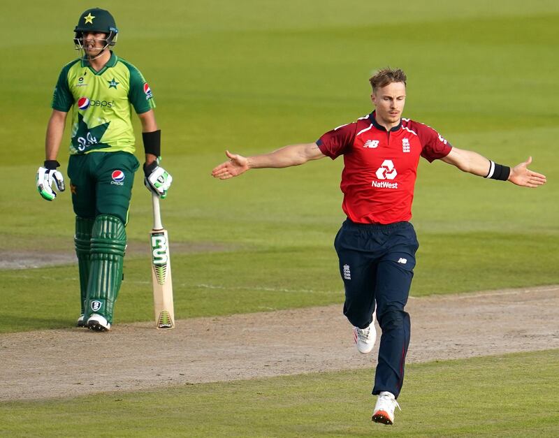 England's Tom Curran (R) celebrates bowling out Pakistan's Babar Azam for 21 runs during the international Twenty20 cricket match between England and Pakistan at Old Trafford cricket ground in Manchester, north-west England, on September 1, 2020. (Photo by Jon Super / POOL / AFP) / RESTRICTED TO EDITORIAL USE. NO ASSOCIATION WITH DIRECT COMPETITOR OF SPONSOR, PARTNER, OR SUPPLIER OF THE ECB
