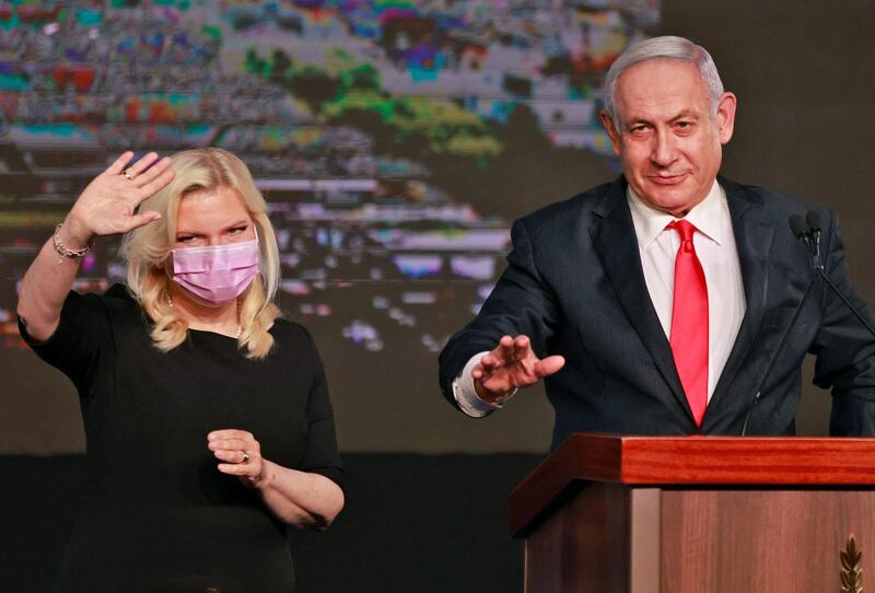 Israeli Prime Minister Benjamin Netanyahu, leader of the Likud party, appears with his wife Sara to address supporters at the party campaign headquarters in Jerusalem. AFP