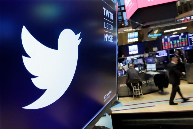 FILE - In this Feb. 8, 2018 file photo, the logo for Twitter is displayed above a trading post on the floor of the New York Stock Exchange.  In a policy published Friday, Nov. 15, 2019 Twitter said it is banning ads that contain references to political content, including appeals for votes, solicitations of financial support and advocacy for or against political content. The ban also includes any ads by candidates, political parties, elected or appointed government officials. (AP Photo/Richard Drew, File)