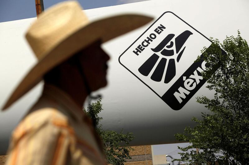 A man passes in front of a logo that says "Made in Mexico", in Ciudad Juarez, Mexico June 1, 2019. REUTERS/Jose Luis Gonzalez