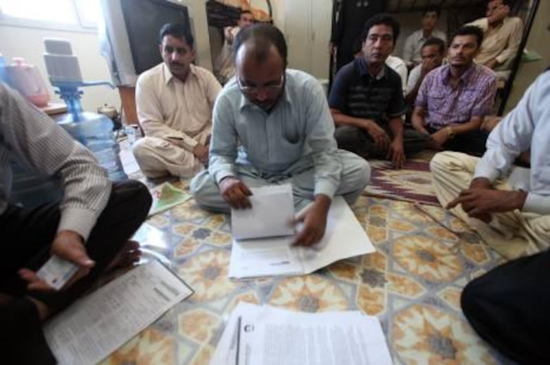 September 20, 2010/  Mussaffa / Taxi drivers from Tawasul gather at an ICAD residential apartment, some with signed contracts in hand from Tawasul; are suing the company for unpaid wages and breach of contract September 20, 2010. (Sammy Dallal / The National)
