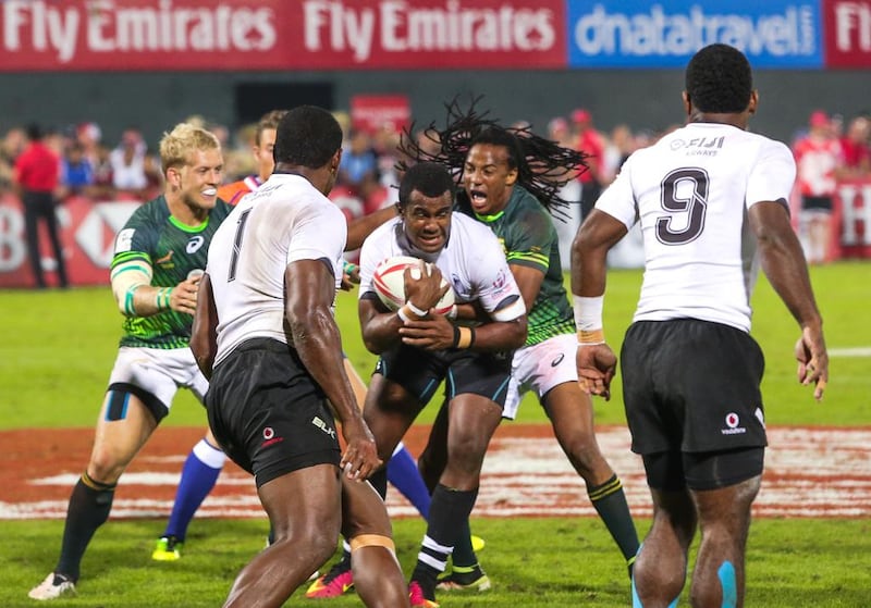 Fiji, white, in action against South Africa during the Dubai Rugby Sevens final on December 2, 2016. South Africa won the game 26-14 as Fiji surrendered the title they won in 2015. Victor Besa for The National 