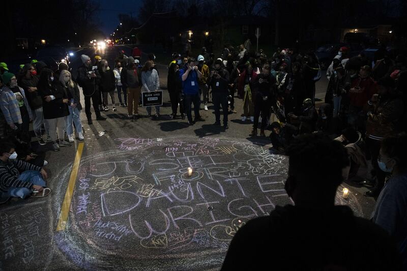 Protesters create a chalk circle that reads 'Justice for Daunte Wright' in the street in Brooklyn Centre, Minnesota, following the death of a man after being shot by police earlier in the day. AFP