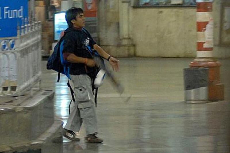 Mohammed Ajmal Kasab walks through the Chatrapathi Sivaji Terminal railway station in Mumbai in 2008 as part of a attack which left 166 people dead.