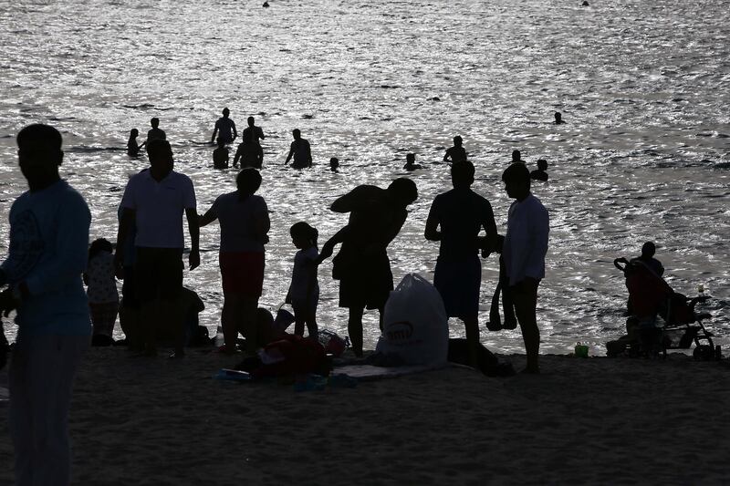 DUBAI , UNITED ARAB EMIRATES Ð June 06 , 2013 : People enjoying during the Israa Wal Meraj holiday at Jumeirah open beach near Burj Al Arab hotel in Dubai. ( Pawan Singh / The National ) For News. 
