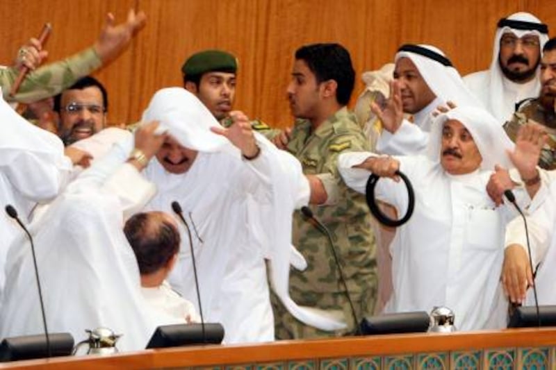 Kuwaiti Shiite and Sunni MPs fight during a heated parliament debate over inmates in the US Guantanamo detention centre in Kuwait City on May 18, 2011 amid rising sectarian tension in the Gulf state. AFP PHOTO/YASSER AL-ZAYYAT
 *** Local Caption ***  024726-01-08.jpg