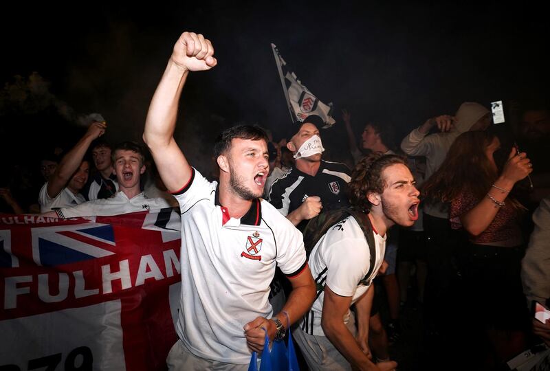 Fulham fans celebrate outside Craven Cottage. PA