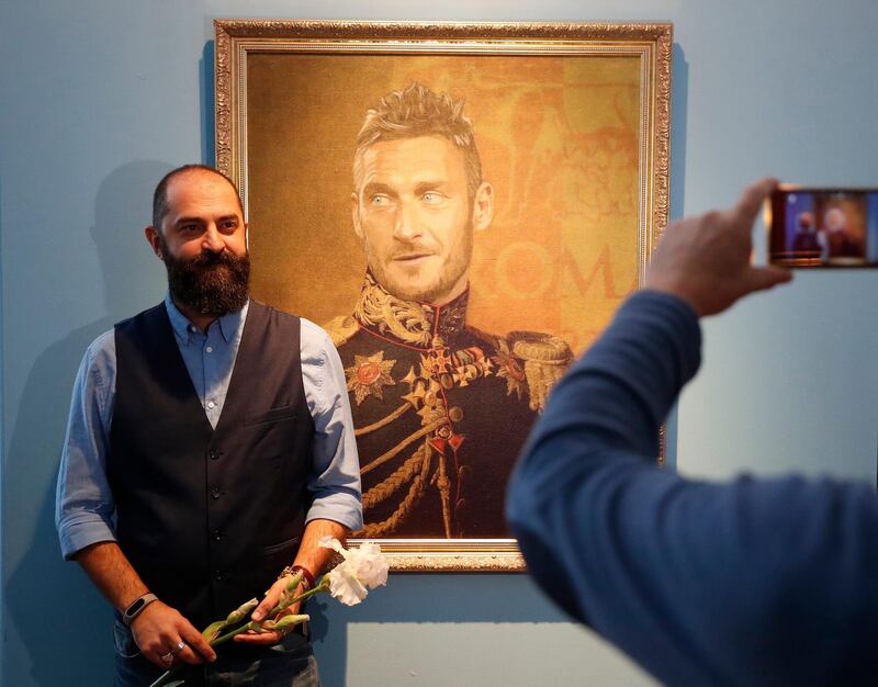 Italian artist Fabrizio Birimbelli poses in front of a portrait of Italian player Francesco Totti during the Art Project 'Like the Gods', presented by the Museum of the Russian Academy of Arts and Birimbelli devoted to the FIFA World Cup of Russia 2018 in St. Petersburg, Russia. Anatoly Maltsev / EPA