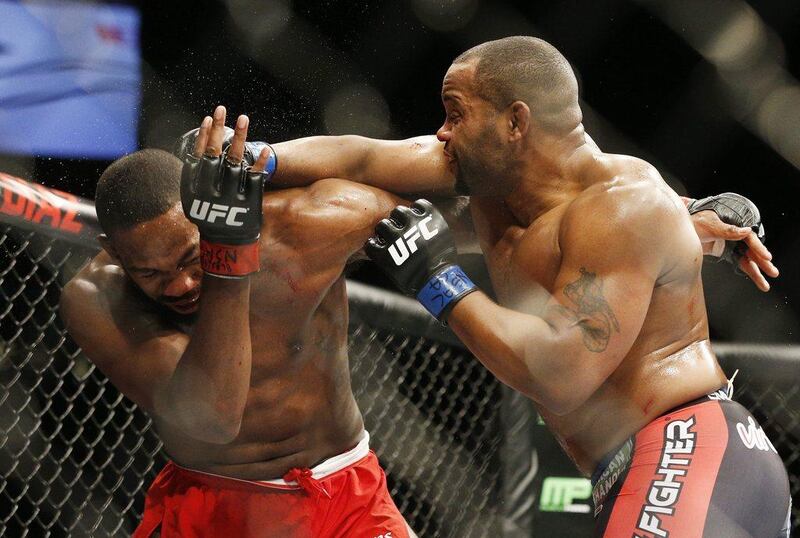 Daniel Cormier hits Jon Jones during their light heavyweight title fight at UFC 182. John Locher / AP