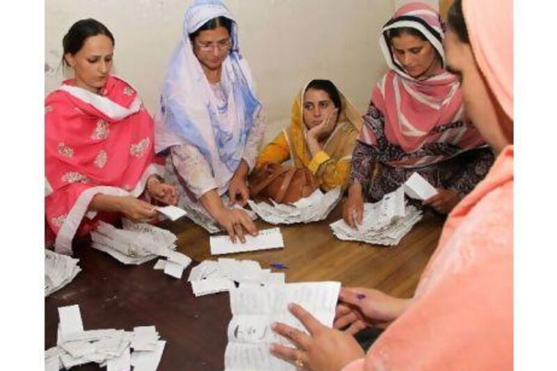 Election commission officials count votes in Muzaffarbad, the capital of Pakistani-administered Kashmir. Rahat Dar / EPA