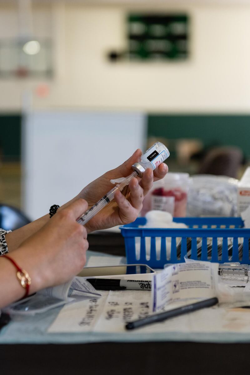 A pharmacist prepares a dose of the Moderna COVID-19 vaccine at the Kenilworth Recreation Center vaccination site in Washington, D.C., U.S., on Tuesday, April 27, 2021. The U.S. economy is on a multi-speed track as minorities in some cities find themselves left behind by the overall boom in hiring, according to a Bloomberg analysis of about a dozen metro areas. Photographer: Eric Lee/Bloomberg