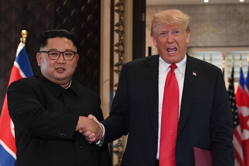 (FILES) In this file photo taken on June 12, 2018 US President Donald Trump (R) and North Korea's leader Kim Jong Un shake hands following a signing ceremony during their historic US-North Korea summit, at the Capella Hotel on Sentosa island in Singapore. President Donald Trump on July 12, 2018 released a letter from Kim Jong Un, in which the North Korean leader voices confidence in efforts to end their nuclear standoff while urging the US leader to take "practical steps" to build trust."A very nice note from Chairman Kim of North Korea. Great progress being made!" Trump tweeted alongside a copy of the letter, dated July 6.In it, Kim describes his landmark June 12 summit with Trump as the "start of a meaningful journey" and expresses confidence that the "sincere efforts" of both sides "will surely come to fruition."
 / AFP / SAUL LOEB

