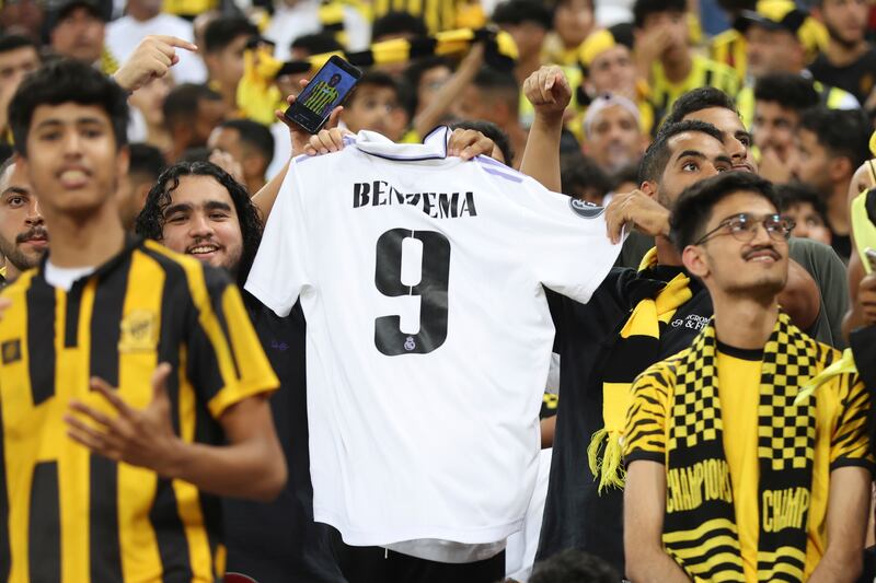 Al Ittihad fans display Karim Benzema's Real Madrid shirt during a presentation ceremony at King Abdullah Sports City Stadium in Jeddah, Saudi Arabia. AP