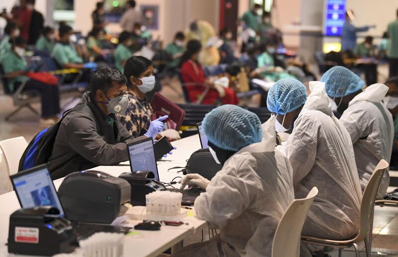 Members of an Indian medical team register for testing upon their arrival at Dubai International Airport on May 9, 2020, to help with the coronavirus (COVID-19) pandemic.  / AFP / Karim SAHIB
