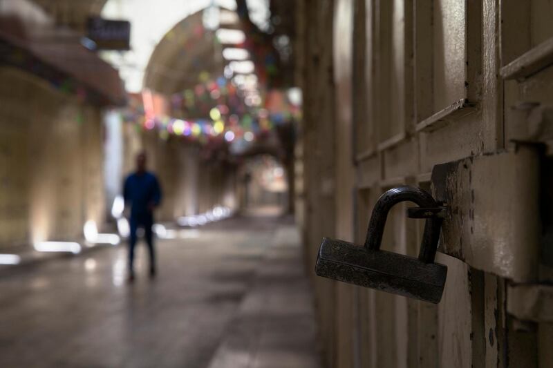 A Palestinian man walks at a closed market during a general strike in the West Bank city of Nablus. AP Photo