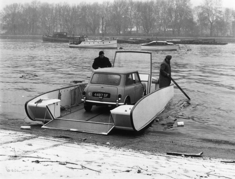 An Aquaglider carries a Mini across the Thames at Putney Pier in London in 1966. Getty Images