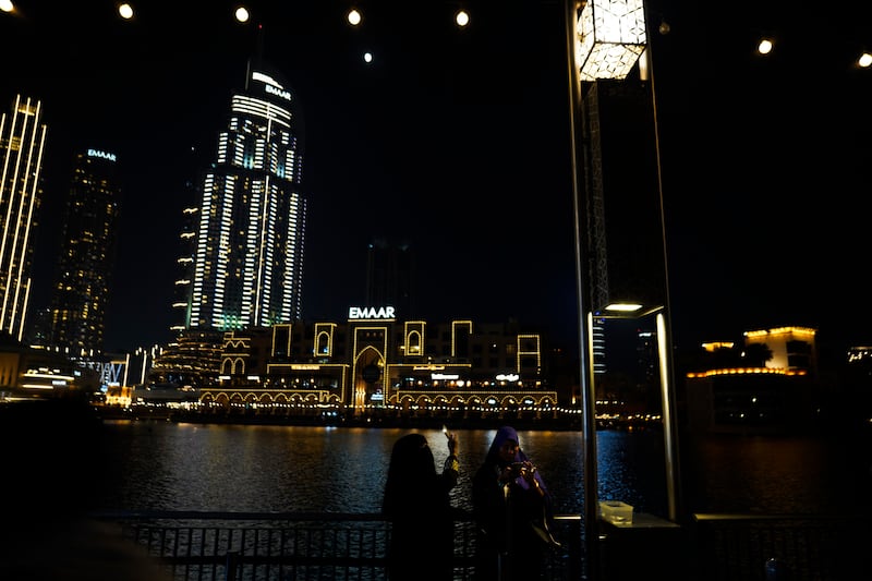Sightseers take photos by the Dubai Fountain near Dubai Mall, one of Emaar's flagship properties. AP