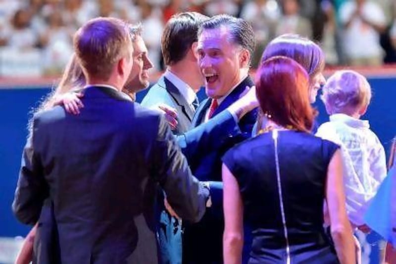 Mitt Romney and his wife Ann hug family members after his speech during the Republican National Convention on Thursday.