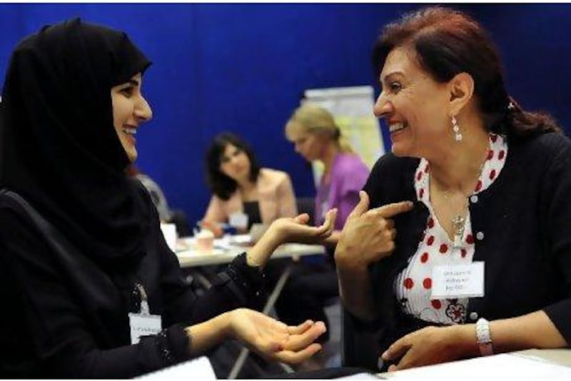 Salama al Romaithi is introduced to her 'big sister', Mahasen al Mahasneh, a career counsellor, at Zayed University. Delores Johnson / The National