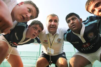 United Arab Emirates - Abu Dhabi - October 21th, 2009: Kids from the British School in Abu Dhabi practice with Lyn Jones, center, who is a former Welsh rugby coach.  (Galen Clarke/The National)