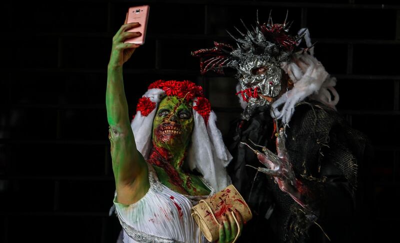 People in costumes participate during the "Zombie Walk." AFP