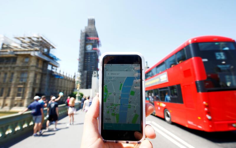 FILE PHOTO: A photo illustration shows the Uber app and a bus in London, Britain, June 25, 2018. REUTERS/Henry Nicholls/Illustration/File Photo