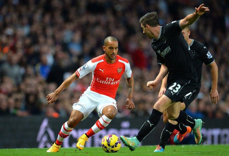 Arsenal's Theo Walcott tries to dribble around Burnley's Stephen Ward during his side's 3-0 Premier League victory on Saturday. Glyn Kirk / AFP / November 1, 2014 