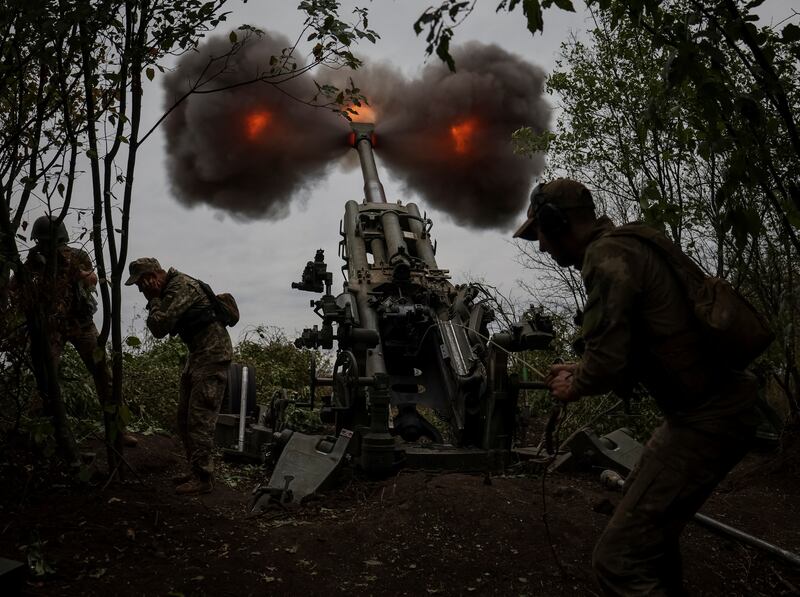 Ukrainian service members fire a shell from a M777 Howitzer in Kharkiv. Reuters