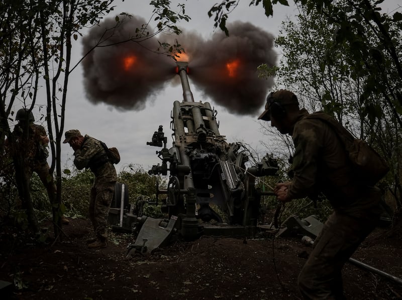 Ukrainian service members fire a shell from a M777 Howitzer in Kharkiv. Reuters
