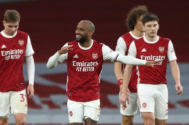 Arsenal's Alexandre Lacazette, centre, celebrates after scoring his side's second goal during the English Premier League soccer match between Arsenal and Tottenham Hotspur at the Emirates stadium in London, England, Sunday, March 14, 2021. (Nick Potts/Pool via AP)