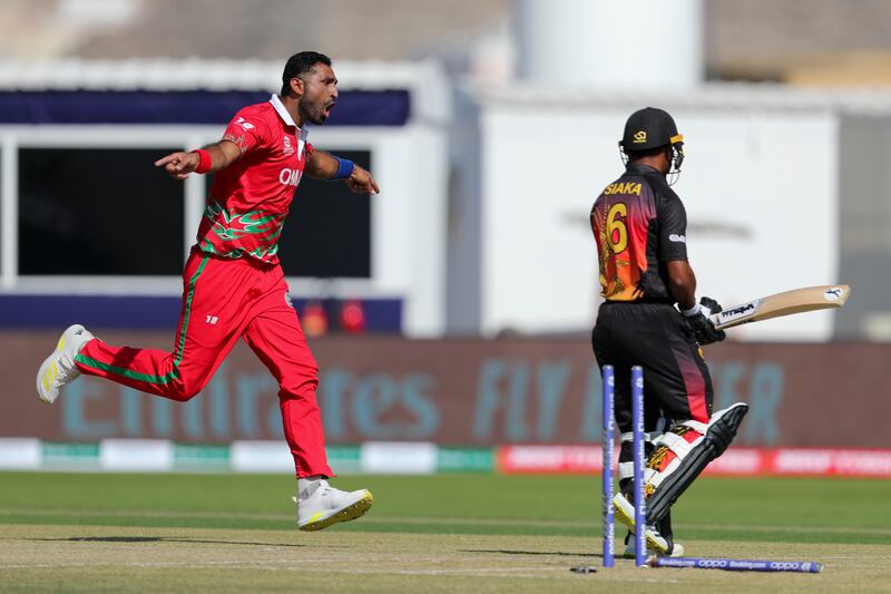 Oman's K Kaleemullah, left, celebrates after dismissing Papua New Guinea's Lega Siaka. AP