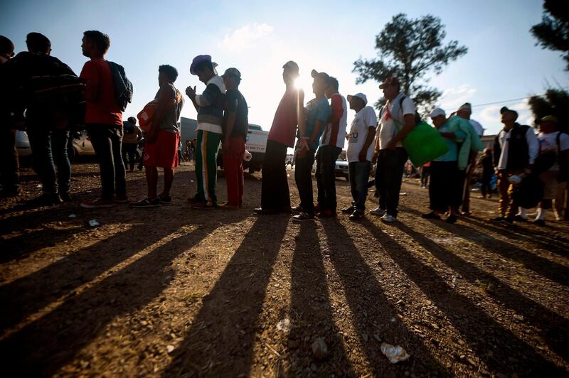 Central American migrants queue to receive a meal at a temporary shelter in Irapuato, Guanajuato state, Mexico. AFP