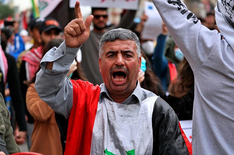 A protester chants anti-government slogans during a rally in Baghdad, Iraqs. AP Photo